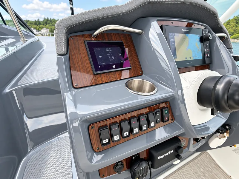 Slide: The Image of The cockpit of the 2020 Cruisers Yachts 35 Express features modern navigation equipment and controls. - 30