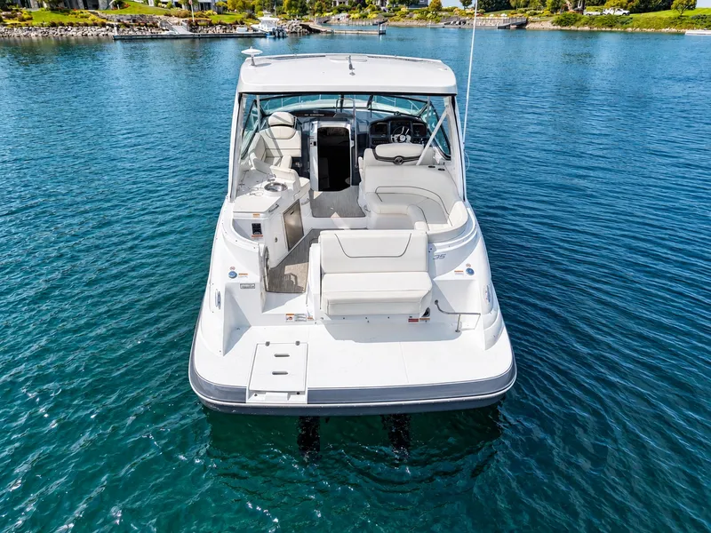 Slide: The Image of A 2020 Cruisers Yachts 35 Express on calm water, featuring a spacious cockpit and seating area. - 17