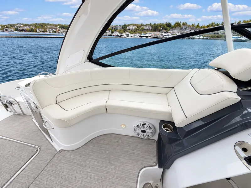 Slide: The Image of The 2020 Cruisers Yachts 35 Express features an elegant white seating area overlooking the water. - 27