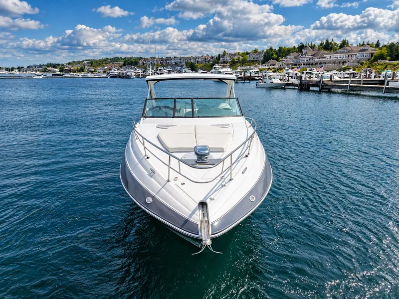 Slide: The Image of A sleek 2020 Cruisers Yachts 35 Express sits in a calm harbor, surrounded by scenic buildings. - 6
