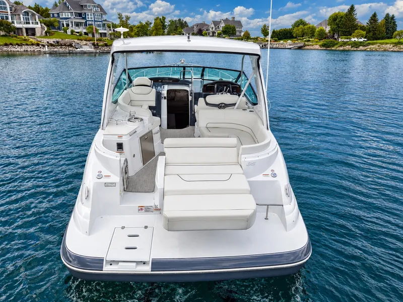 Slide: The Image of The 2020 Cruisers Yachts 35 Express is on calm water, featuring an open cockpit with white seating. - 14