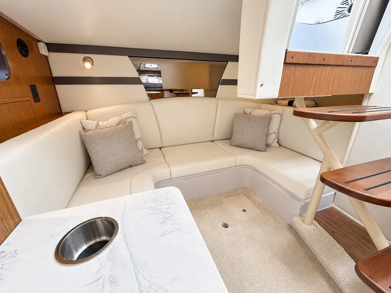 Slide: The Image of Interior of a 2020 Cruisers Yachts 35 Express with elegant seating area and table. - 46