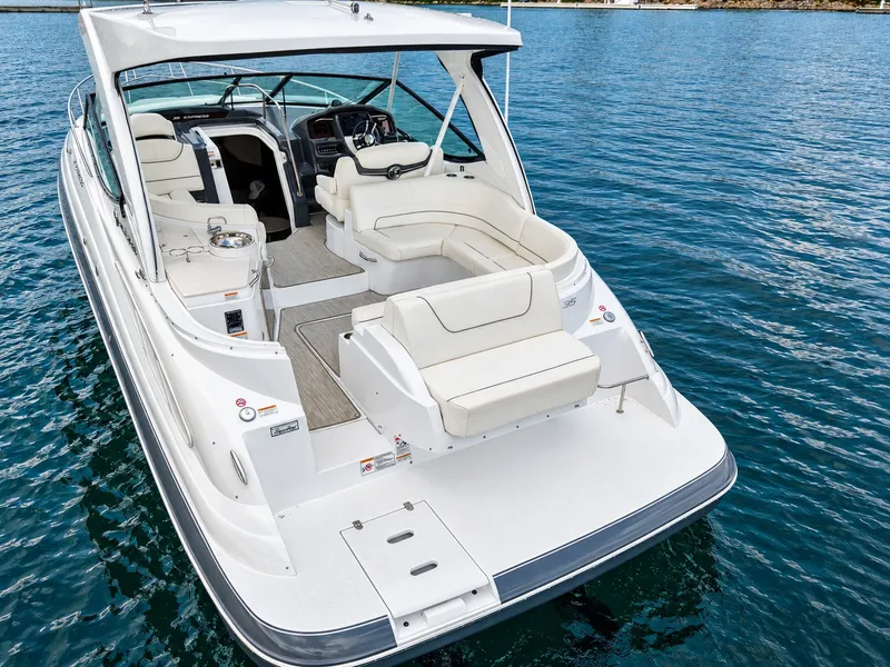 Slide: The Image of A luxurious white yacht with an open cockpit and comfortable seating, floating on calm water. - 13