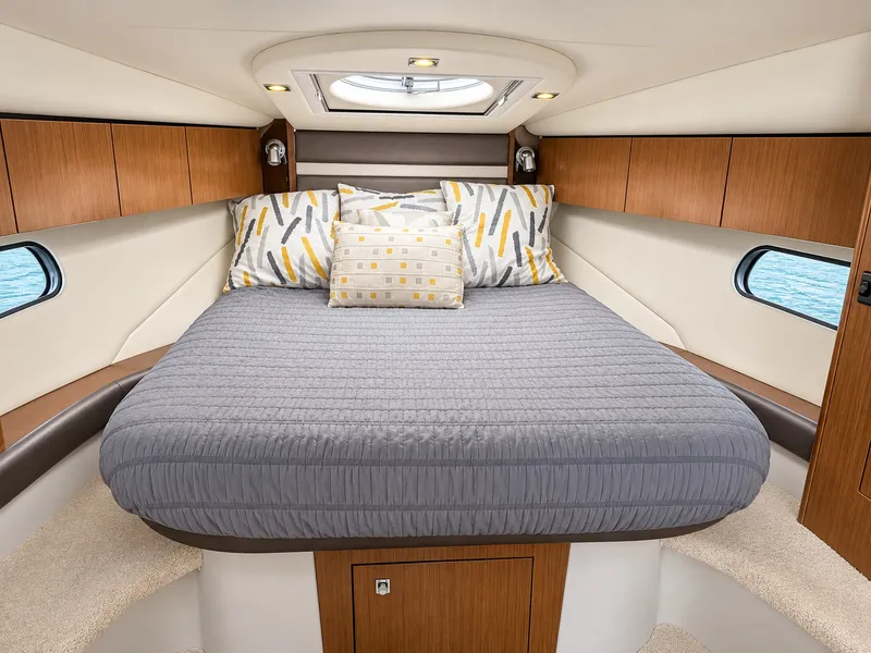 Slide: The Image of The cabin of the 2020 Cruisers Yachts 35 Express features a cozy bed with modern pillows. - 40