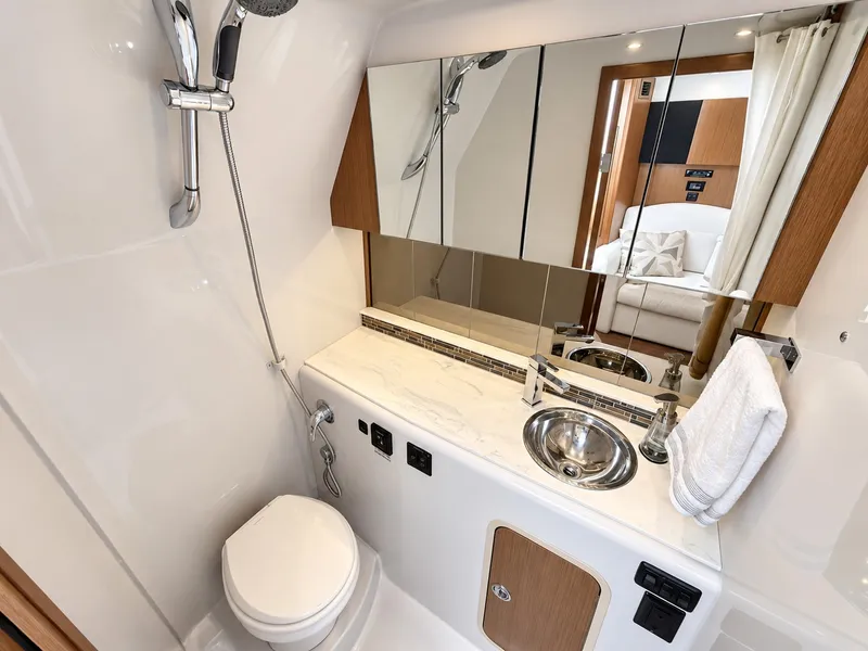 Slide: The Image of The image shows a modern yacht bathroom with a toilet, sink, and mirrors. - 47