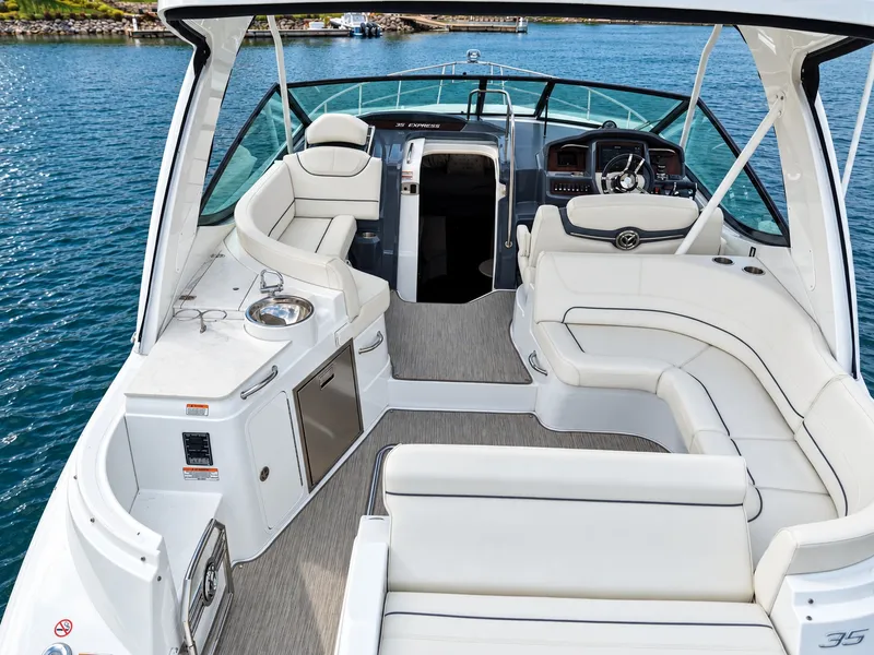Slide: The Image of The image shows the cockpit of a 2020 Cruisers Yachts 35 Express with sleek white seating. - 19