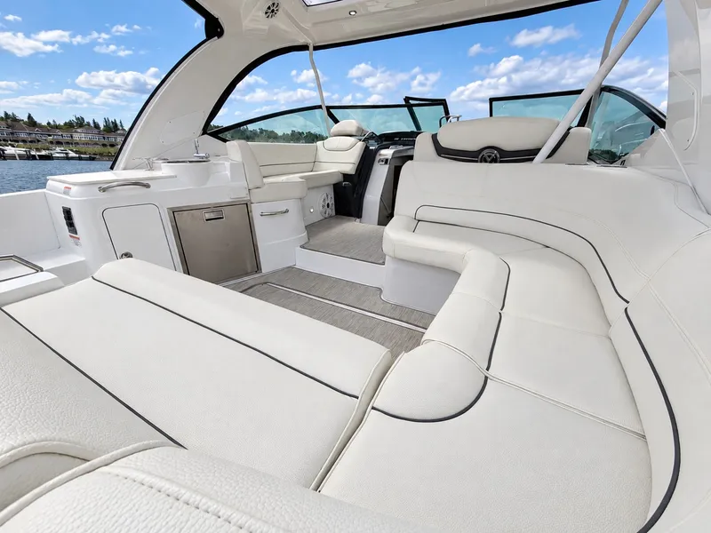 Slide: The Image of The image shows the luxurious cockpit of a 2020 Cruisers Yachts 35 Express with white leather seating. - 22
