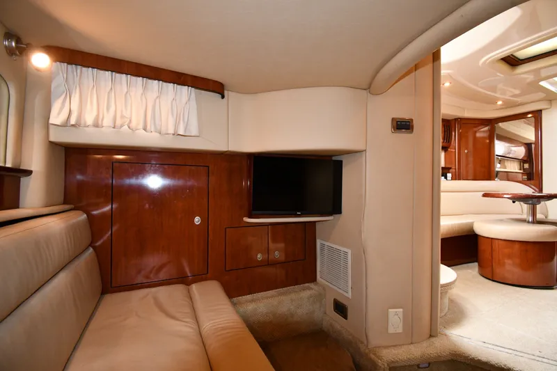 Slide: The Image of Interior of 2004 Sea Ray 420 Sundancer yacht with cozy seating and wooden cabinetry. - 44