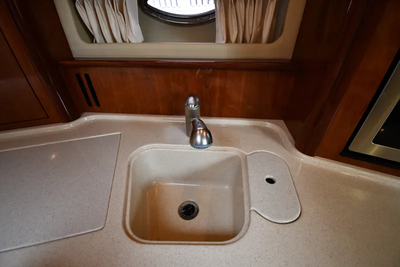 Slide: The Image of 2004 Sea Ray 420 Sundancer kitchen sink with modern faucet and countertop. - 38