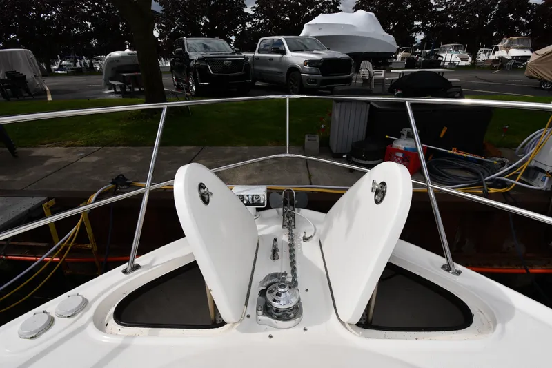 Slide: The Image of Bow view of 2004 Sea Ray 420 Sundancer yacht docked, showcasing anchor and deck details. - 5