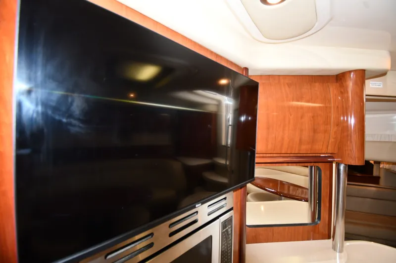 Slide: The Image of Interior of 2004 Sea Ray 420 Sundancer with TV and wood paneling. - 41