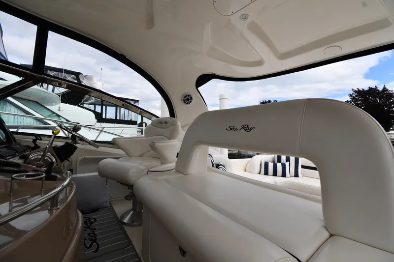 Slide: The Image of Interior of 2004 Sea Ray 420 Sundancer yacht with plush seating and helm. - 14