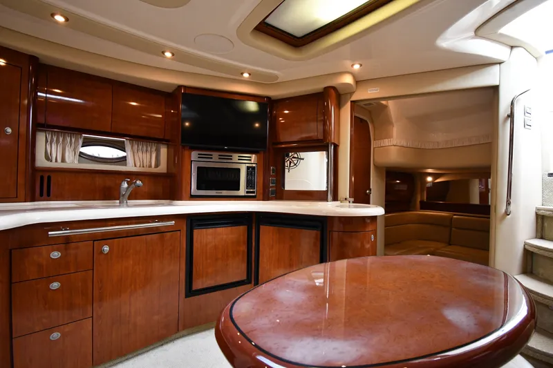 Slide: The Image of Luxurious interior of 2004 Sea Ray 420 Sundancer yacht with wood cabinetry and modern amenities. - 37