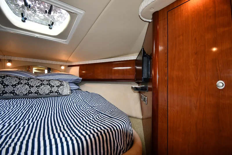 Slide: The Image of Luxurious cabin interior of 2004 Sea Ray 420 Sundancer yacht with striped bedding. - 27