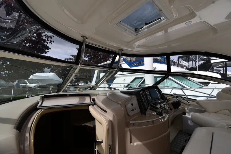 Slide: The Image of Interior view of 2004 Sea Ray 420 Sundancer yacht cockpit with modern controls. - 9