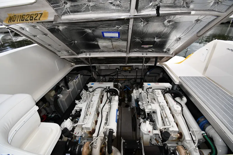 Slide: The Image of Engine compartment of a 2004 Sea Ray 420 Sundancer yacht, showcasing dual engines. - 48
