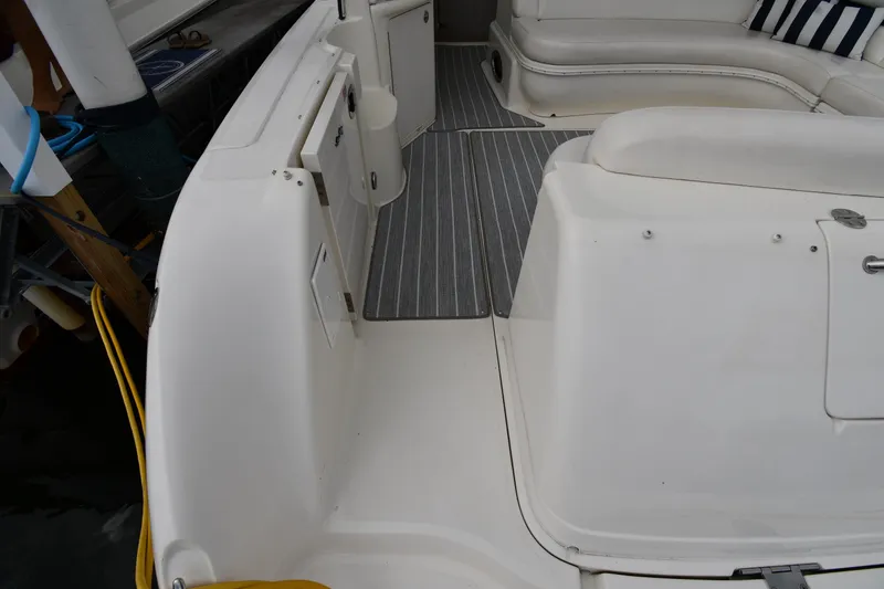 Slide: The Image of 2004 Sea Ray 420 Sundancer boat interior with white seating and striped flooring. - 22