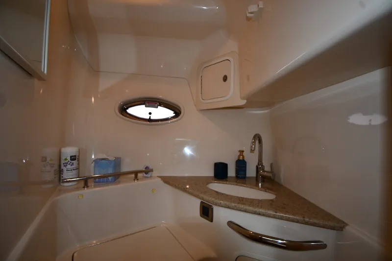 Slide: The Image of Bathroom interior of 2004 Sea Ray 420 Sundancer yacht with sink and porthole. - 46