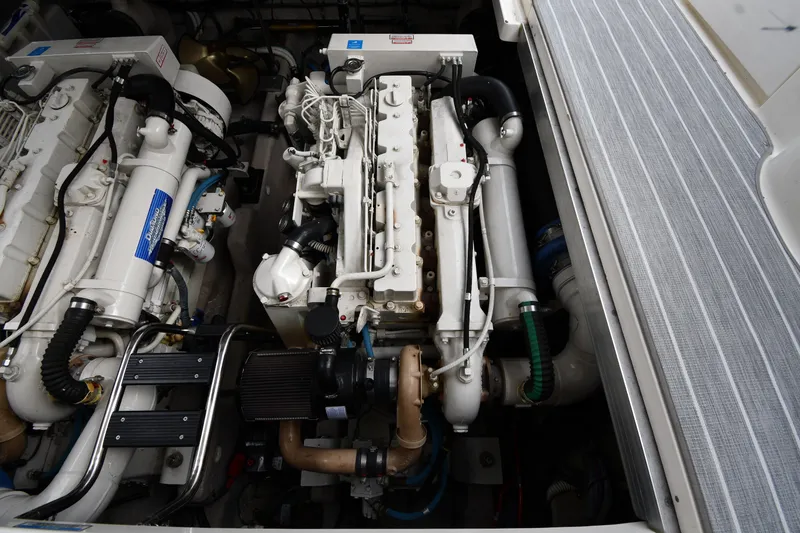 Slide: The Image of Engine compartment of a 2004 Sea Ray 420 Sundancer yacht, showcasing dual engines. - 49
