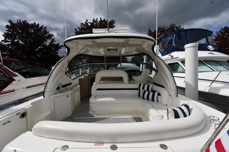 Slide: The Image of 2004 Sea Ray 420 Sundancer yacht with spacious seating and striped cushions. - 8