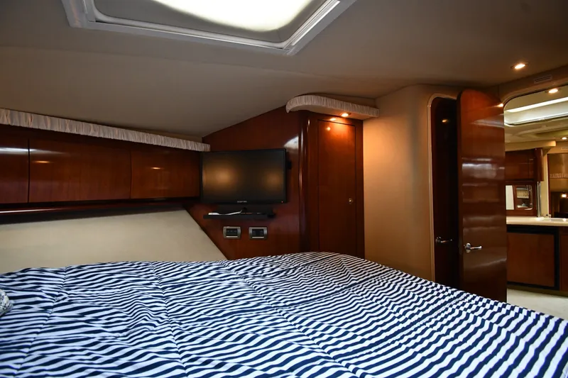 Slide: The Image of Luxurious cabin interior of 2004 Sea Ray 420 Sundancer yacht with striped bedding. - 30