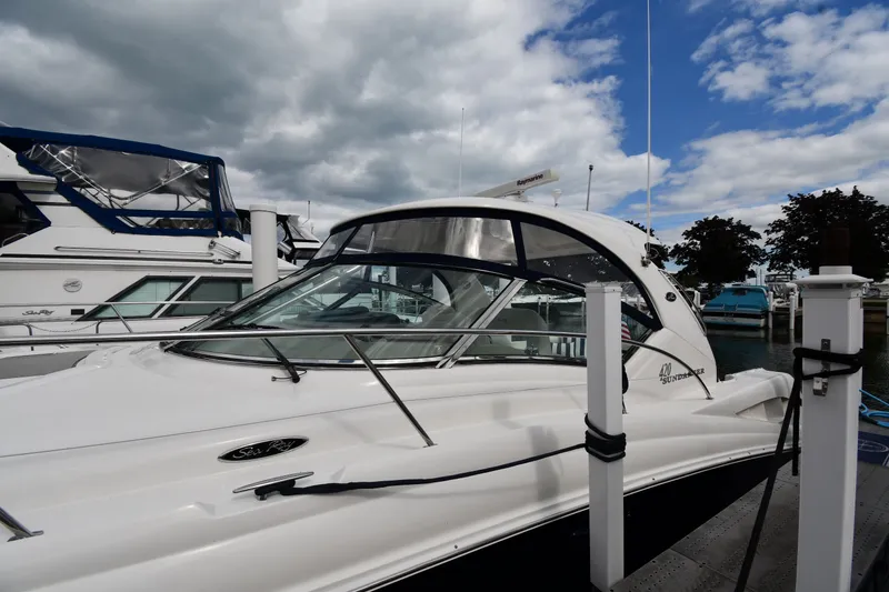 Slide: The Image of 2004 Sea Ray 420 Sundancer yacht docked under cloudy sky. - 2