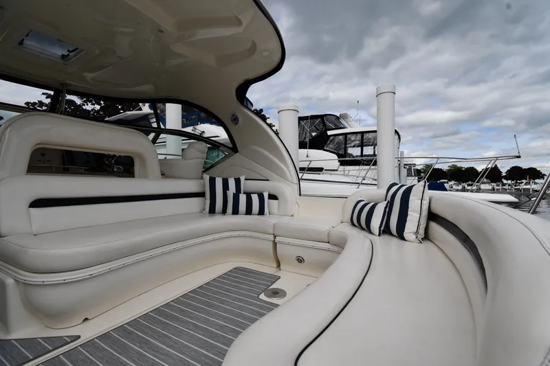 Slide: The Image of Luxurious 2004 Sea Ray 420 Sundancer yacht interior with plush seating and striped cushions. - 15