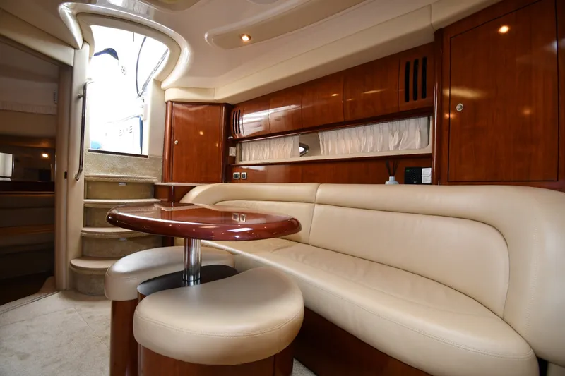 Slide: The Image of Luxurious interior of a 2004 Sea Ray 420 Sundancer yacht with elegant seating and wooden finishes. - 36