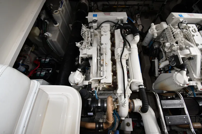 Slide: The Image of Engine room of a 2004 Sea Ray 420 Sundancer, showcasing dual engines and mechanical components. - 50