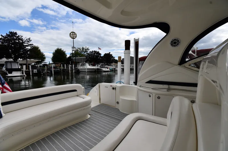 Slide: The Image of 2004 Sea Ray 420 Sundancer yacht interior at marina, featuring sleek seating and modern design. - 20