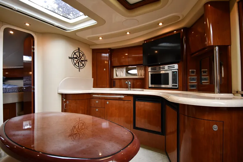 Slide: The Image of Luxurious interior of 2004 Sea Ray 420 Sundancer yacht with modern kitchen amenities. - 34