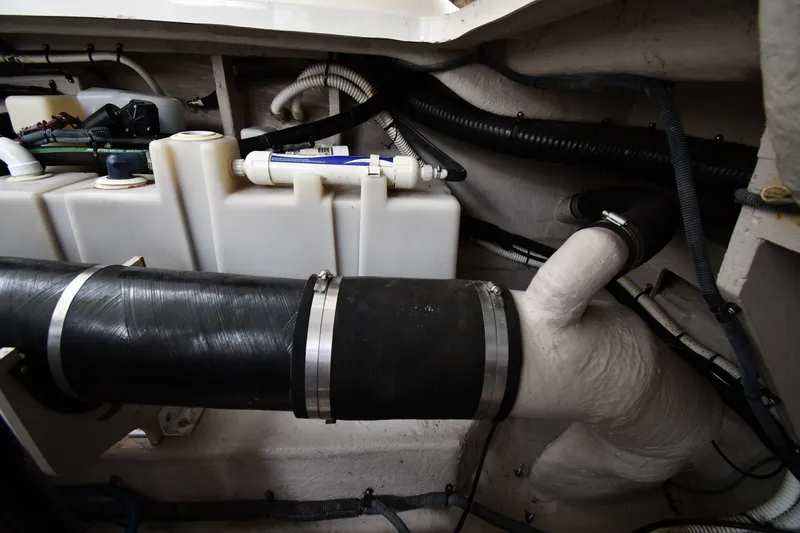 Slide: The Image of Engine compartment of a 2004 Sea Ray 420 Sundancer, showing hoses and components. - 53
