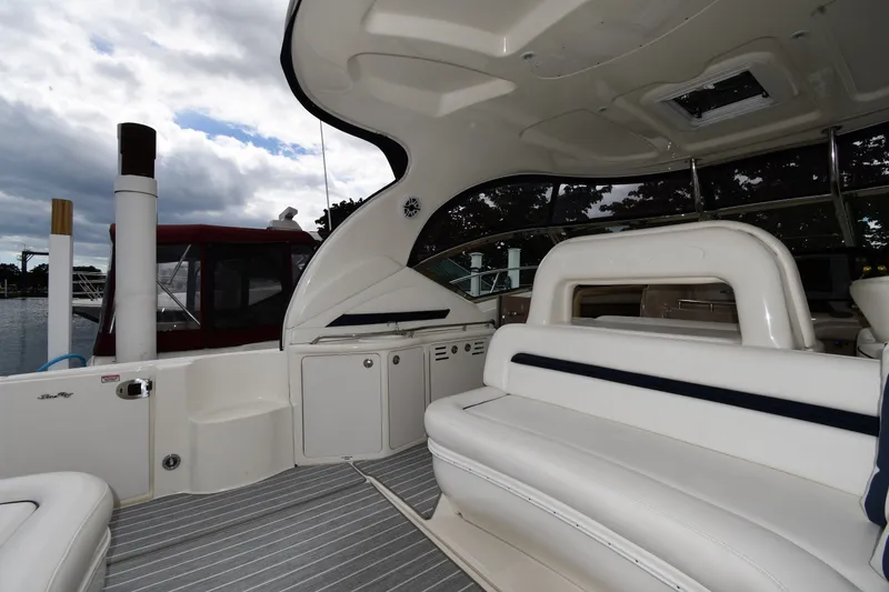 Slide: The Image of 2004 Sea Ray 420 Sundancer interior with white seating and striped flooring. - 16