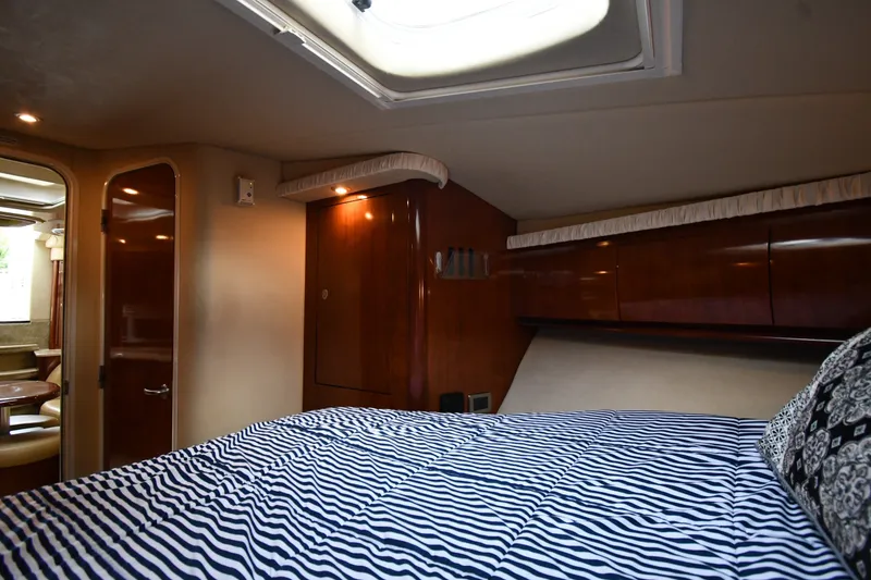 Slide: The Image of Luxurious cabin interior of 2004 Sea Ray 420 Sundancer yacht with striped bedding. - 29