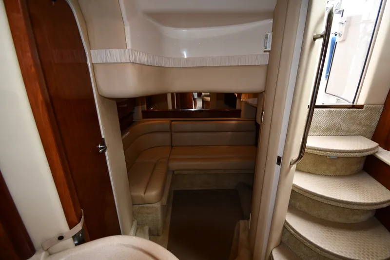 Slide: The Image of Interior of 2004 Sea Ray 420 Sundancer yacht with beige seating and curved staircase. - 42
