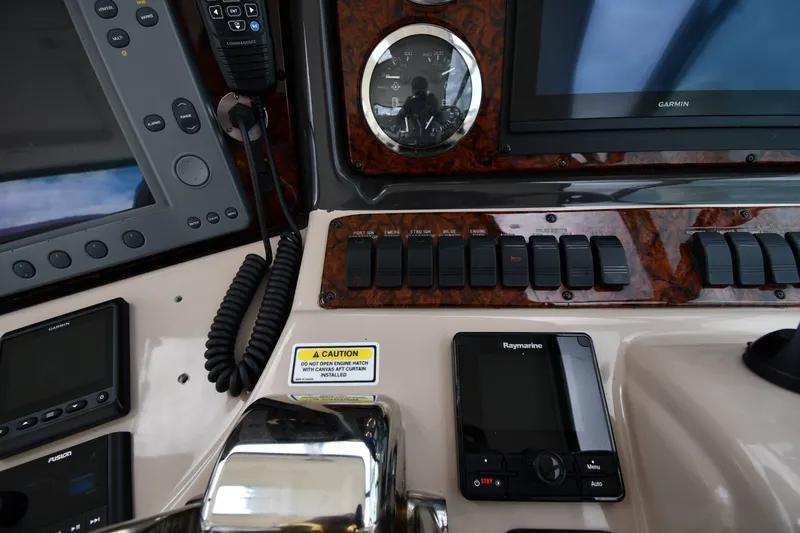 Slide: The Image of Control panel of a 2004 Sea Ray 420 Sundancer with navigation and communication equipment. - 12