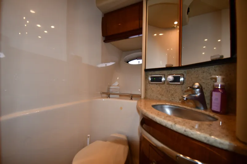 Slide: The Image of Luxurious bathroom in 2004 Sea Ray 420 Sundancer yacht with granite countertop and modern fixtures. - 32