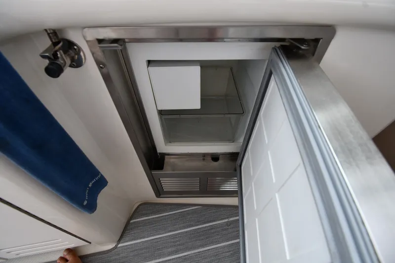 Slide: The Image of Open refrigerator on 2004 Sea Ray 420 Sundancer yacht, showing interior shelves. - 19