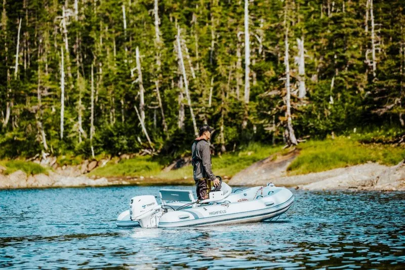 The Image of Man on Highfield Classic 340 boat in forest lake, 2026. - 0