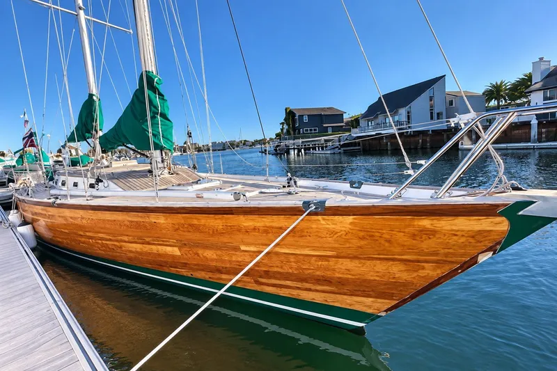 Slide: The Image of Elegant 2007 Chuck Burns Custom 49 Schooner docked in a serene marina setting. - 5