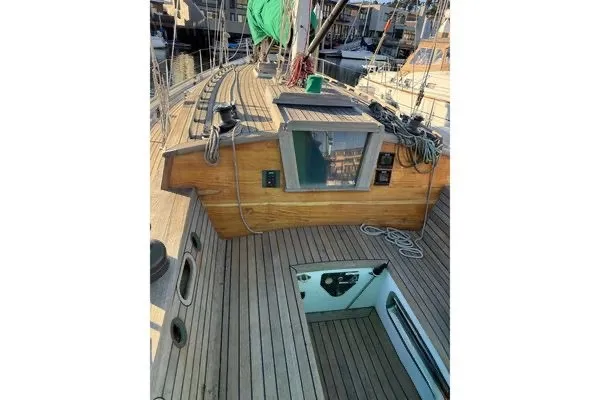 Slide: The Image of Wooden deck of 2007 Chuck Burns Custom 49 Schooner, featuring ropes and hatch. - 8