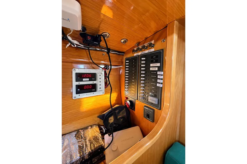 Slide: The Image of Electrical panel inside a 2007 Chuck Burns Custom 49 Schooner, featuring gauges and switches. - 12