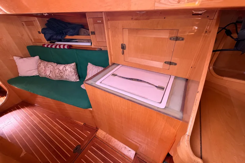 Slide: The Image of Interior of 2007 Chuck Burns Custom 49 Schooner with green seating and wooden cabinetry. - 20