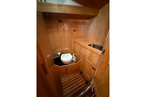 Slide: The Image of Wood-paneled bathroom in 2007 Chuck Burns Custom 49 Schooner with toilet and sink. - 13