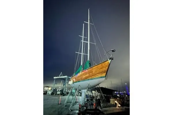 Slide: The Image of Custom 49 Schooner by Chuck Burns, 2007, docked at night with illuminated masts. - 5