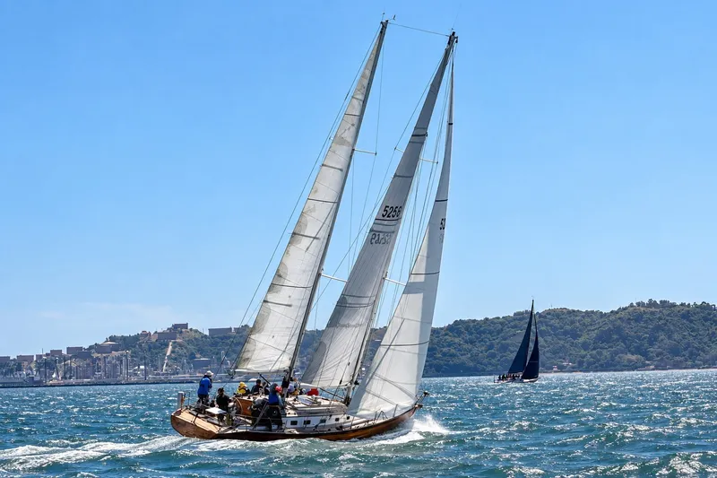 Slide: The Image of Sailing on a Chuck Burns Custom 49 Schooner, 2007, against a scenic coastal backdrop. - 3