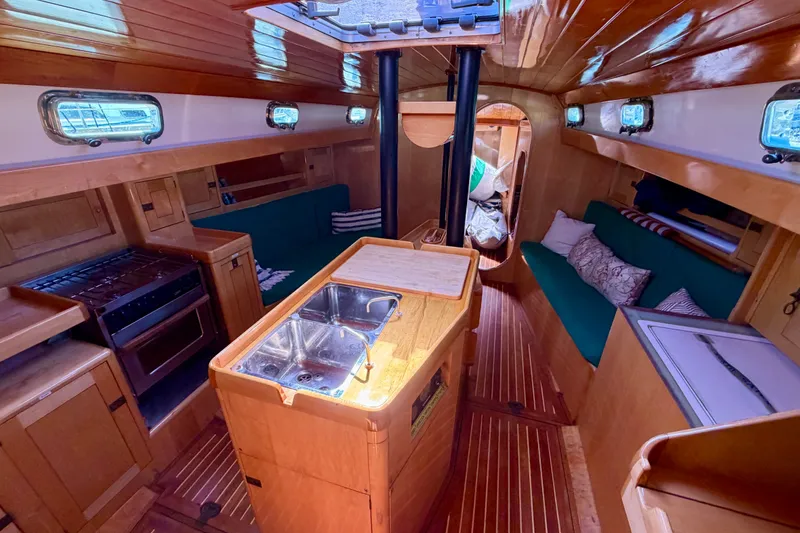 Slide: The Image of Interior of 2007 Chuck Burns Custom 49 Schooner with wood finish and cozy seating. - 16