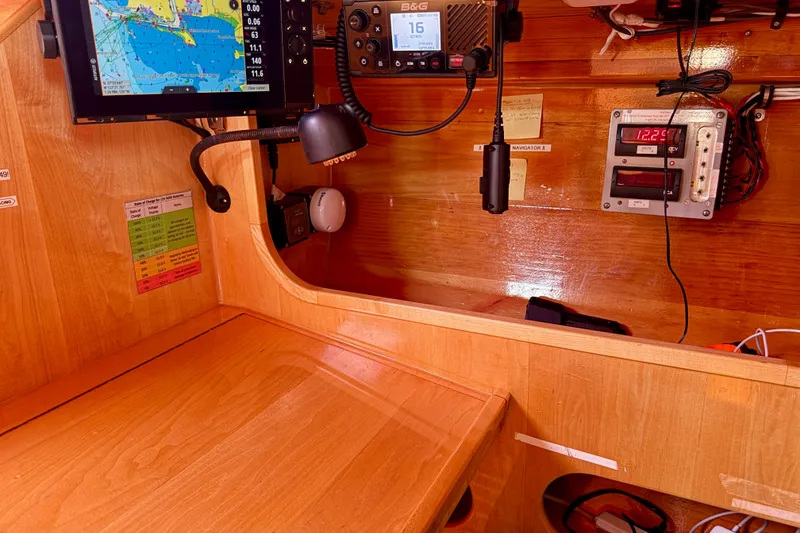 Slide: The Image of Navigation station of a 2007 Chuck Burns Custom 49 Schooner with electronic equipment. - 10