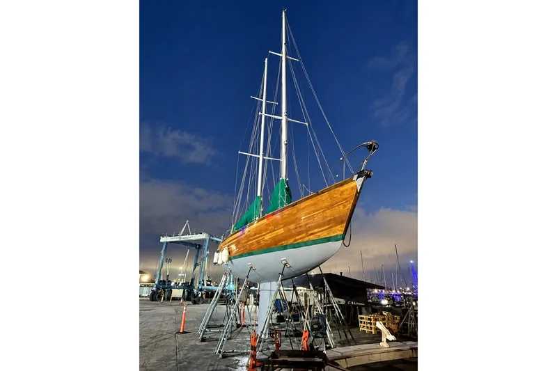 Slide: The Image of Custom 49 Schooner by Chuck Burns, 2007, docked at night under a clear sky. - 4