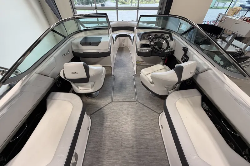 Slide: The Image of Interior of a 2015 Regal 2300 Bowrider boat with seating and steering wheel. - 17